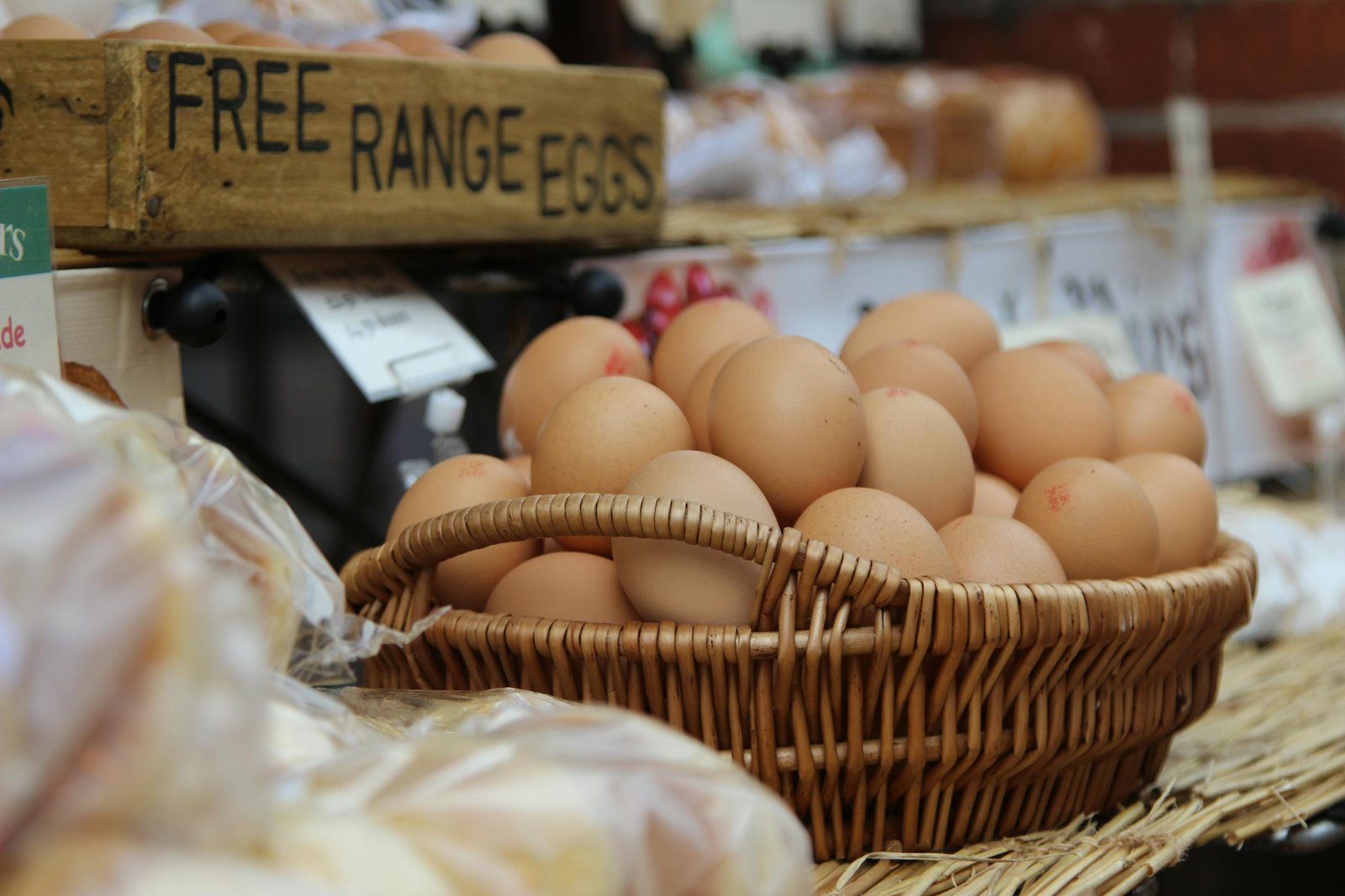 A basket of brown free range eggs displayed at a market, highlighting fresh, natural ingredients.