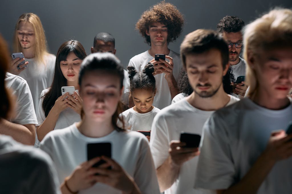 A diverse group of people engrossed in their smartphones, highlighting modern social connectivity.