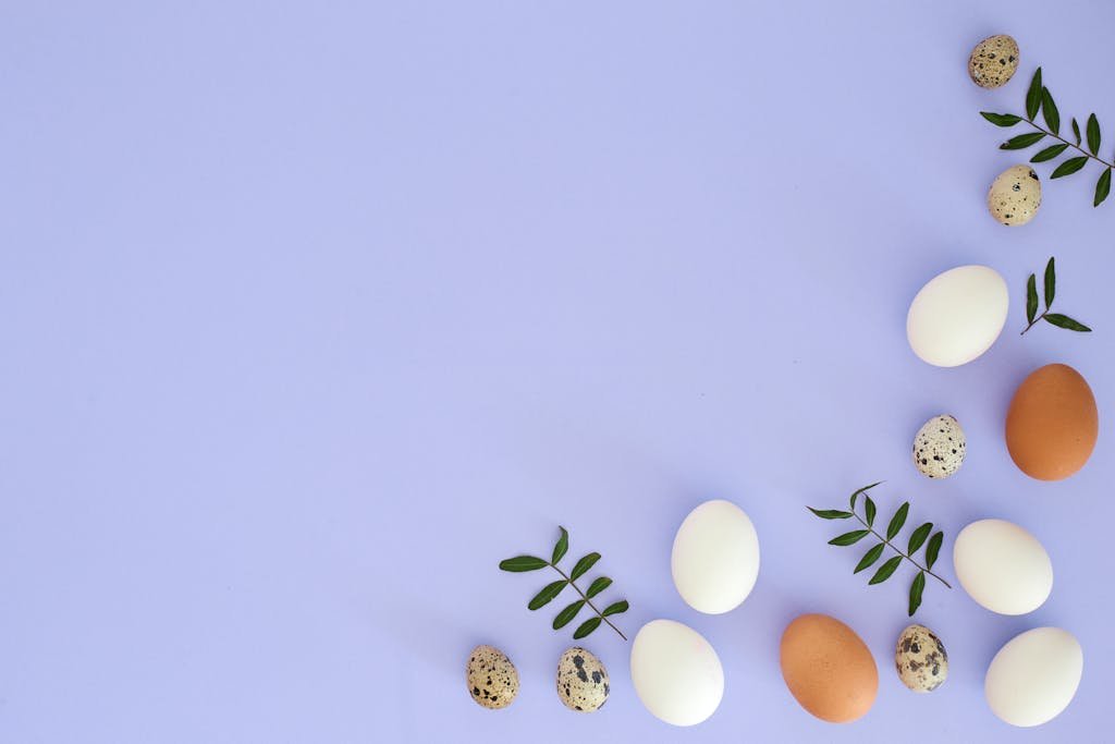 Easter Photo of Eggs and Leaves on a Pastel Blue Background